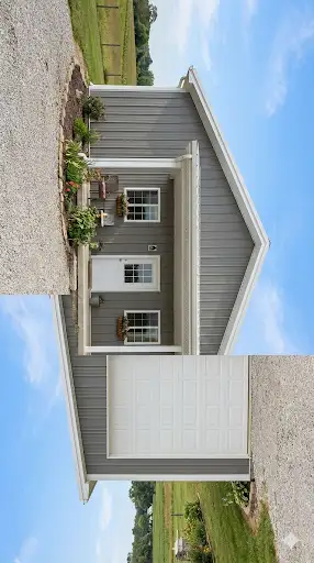 Small metal home with attached large garage shop